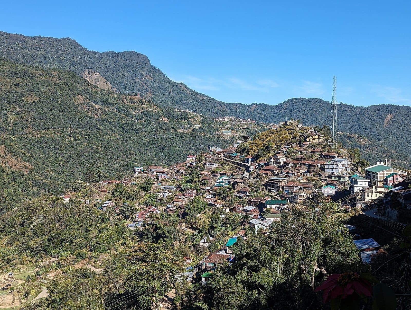 Khonoma village built along a hilltop, surrounded by forested mountains